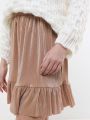  חצאית מיני נקודות מטאליות עם פפלום של YANGA