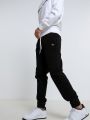 מכנסי טרנינג עם פאץ' לוגומכנסי טרנינג עם פאץ' לוגו של CHAMPION image №2